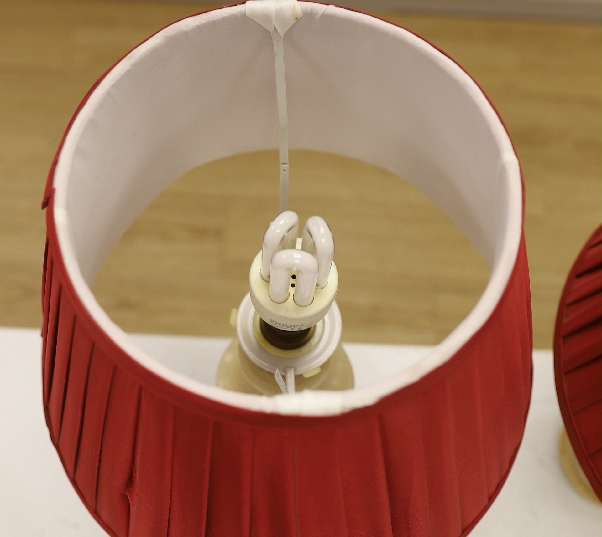 A pair of shaped alabaster table lamps, with shades, each 50cm high